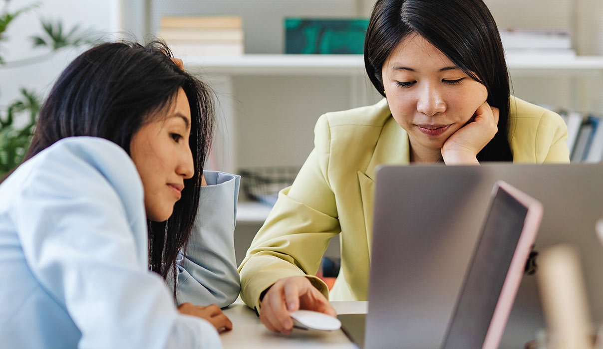 Two Women Looking at Laptop Two Women Looking at Laptop